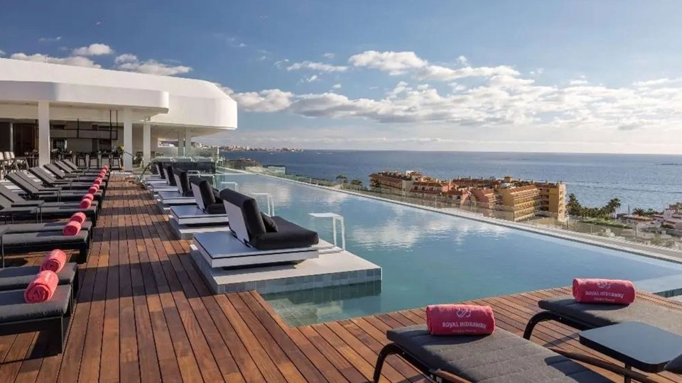 a large swimming pool with a view of the ocean