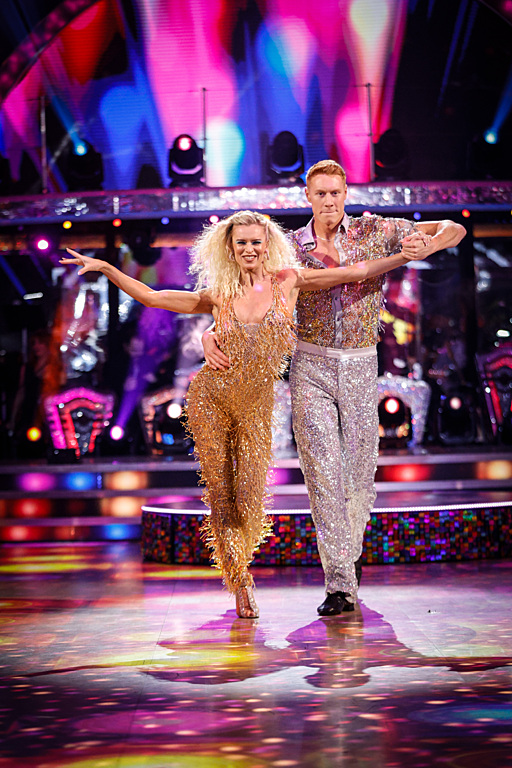 a man and a woman are dancing on a stage