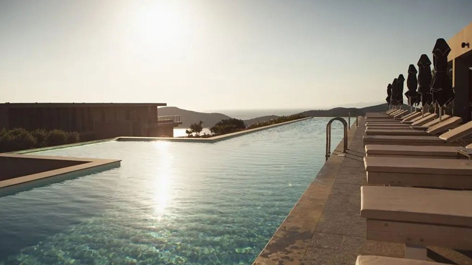 a large swimming pool with a view of the ocean
