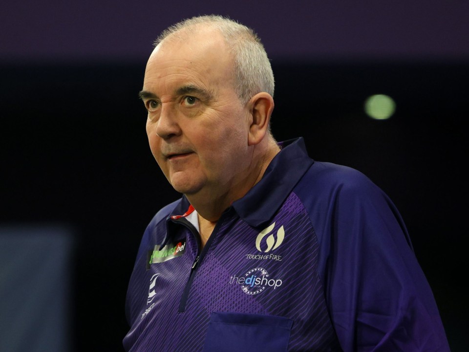 a man wearing a purple shirt that says mediashop on it