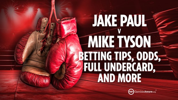 a pair of red boxing gloves hanging in a boxing ring