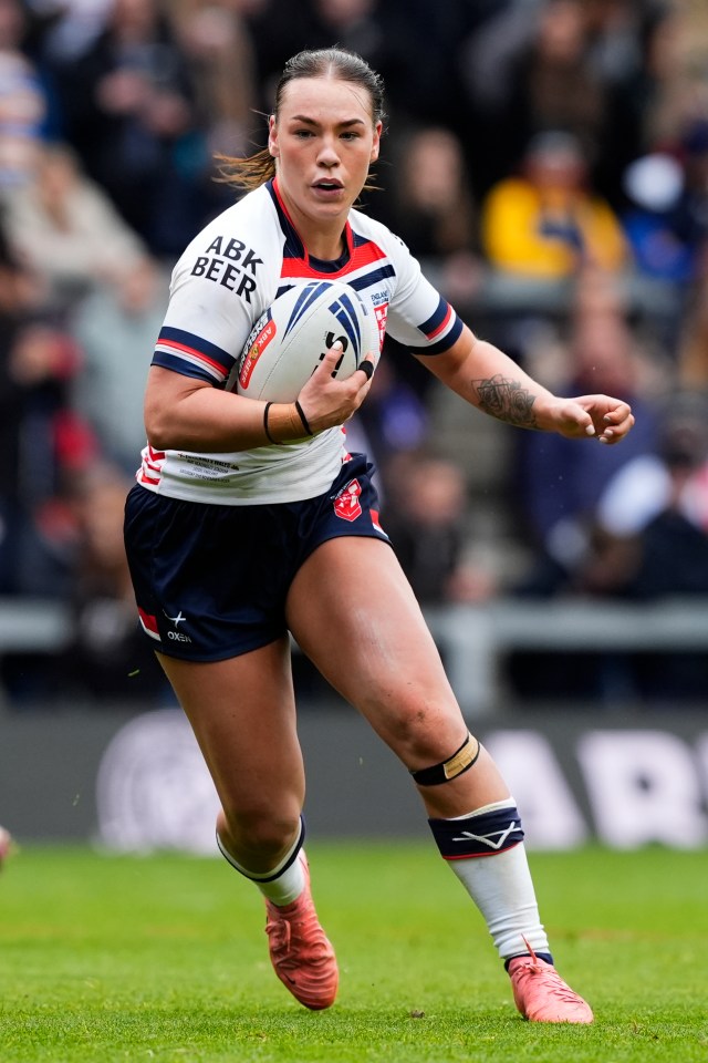 a female rugby player wearing a shirt that says abk beer
