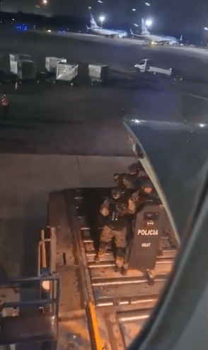 Officers were raised up on the cargo lift to the hold of the plane