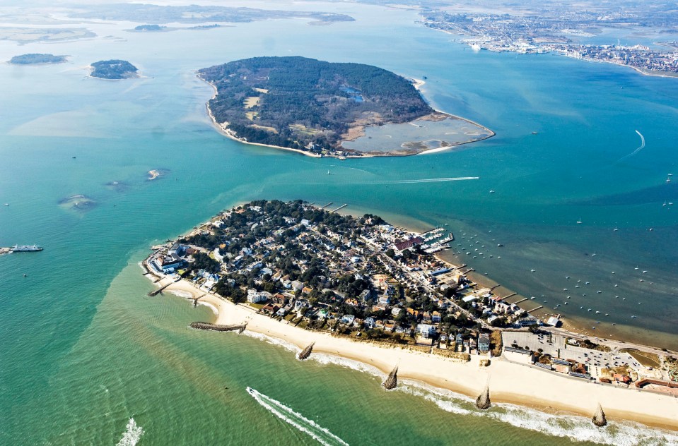 an aerial view of a small island in the middle of a body of water