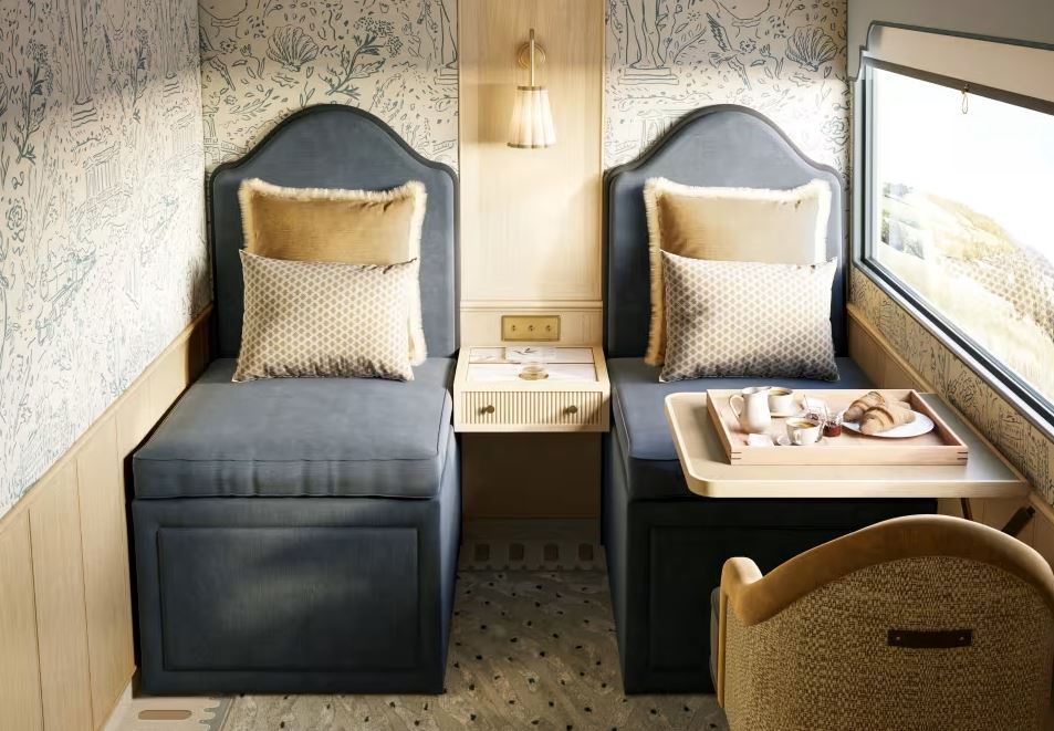 a room with two chairs and a table with a tray of food on it