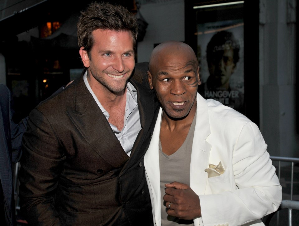 mike tyson and brad pitt are posing for a picture