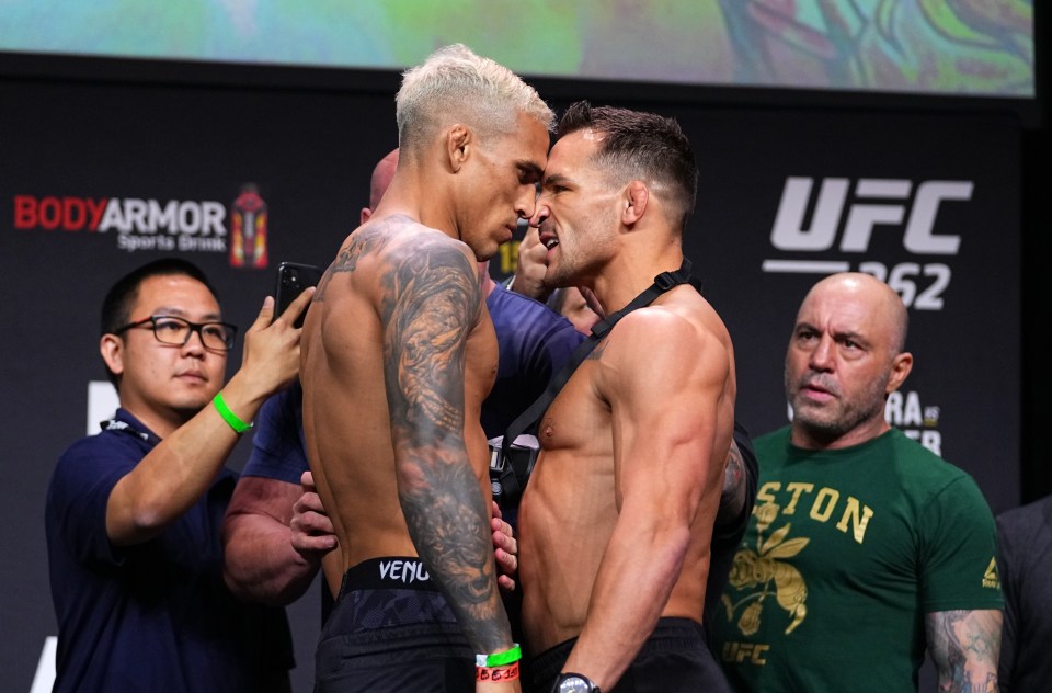 two men standing next to each other in front of a sign that says ufc