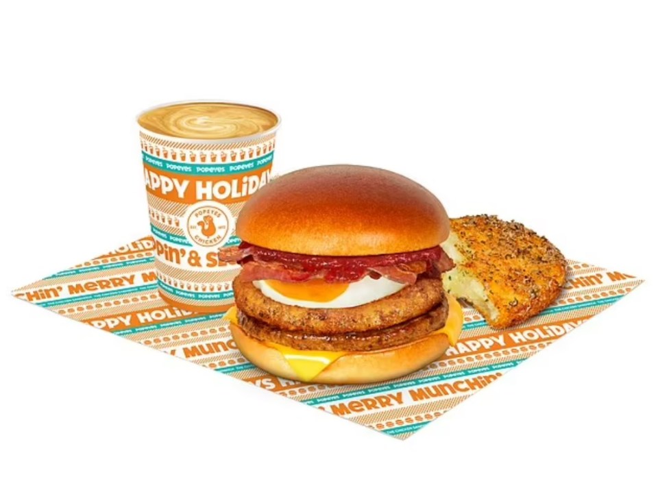 a sandwich and a cup that says happy holiday on it