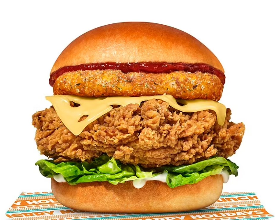 a fried chicken sandwich sits on a paper that says happy holidays