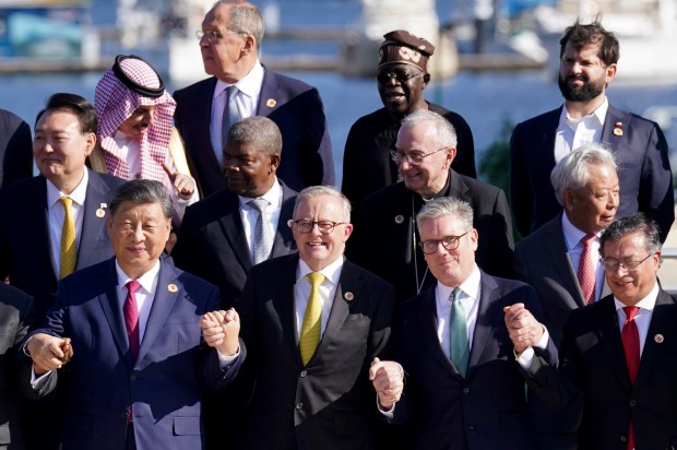 a group of men in suits and ties are posing for a picture
