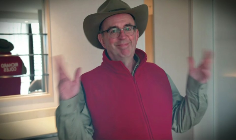 a man wearing a red vest that says omaha flags