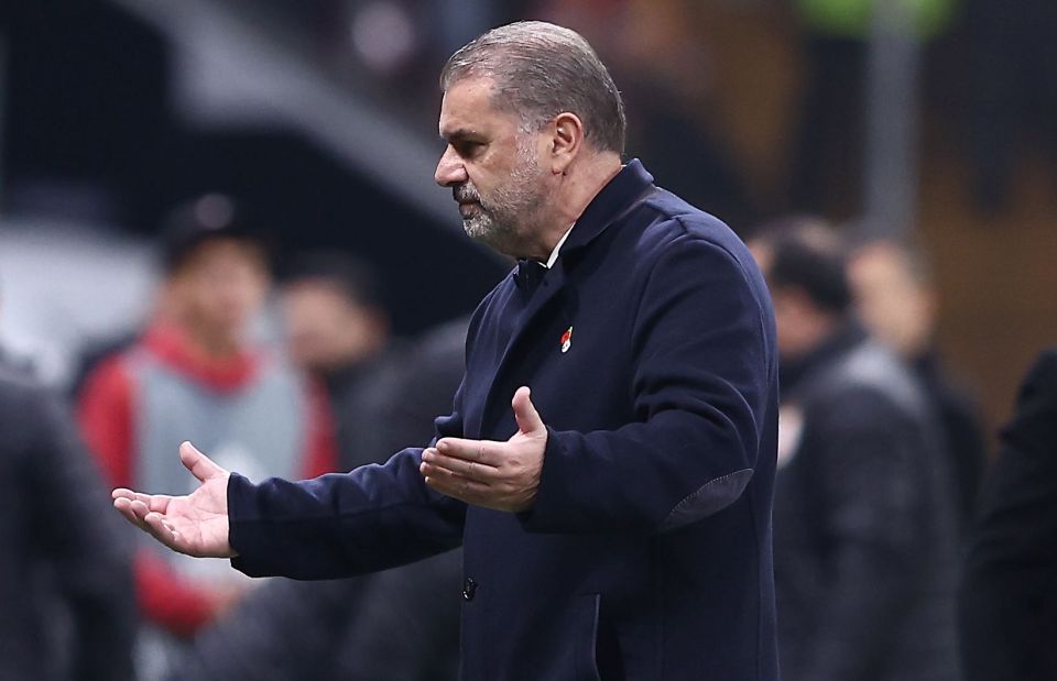 a man with a beard wearing a jacket with a red heart on it