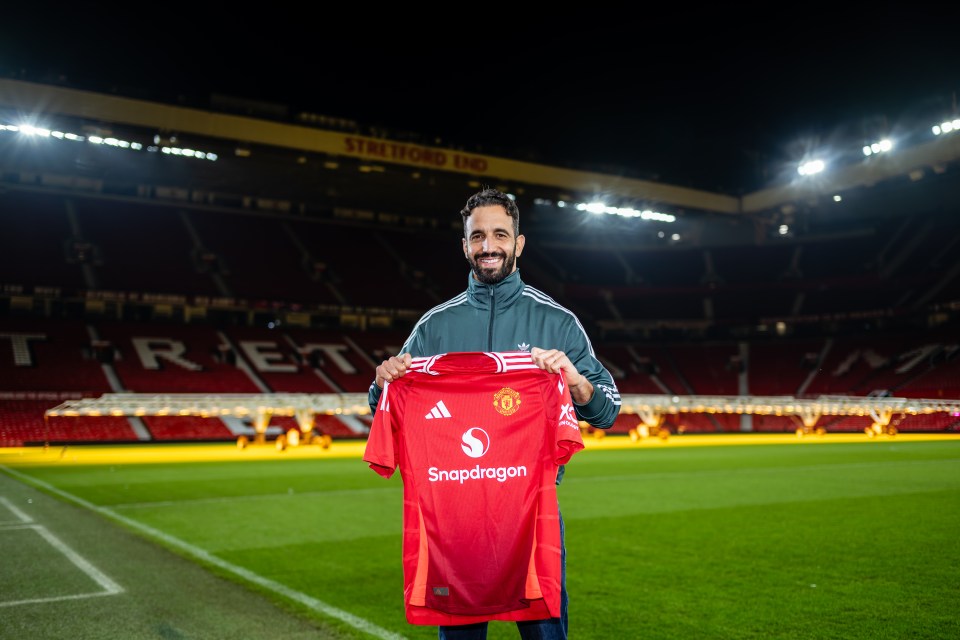 a man holds up a snapdragon shirt on a soccer field