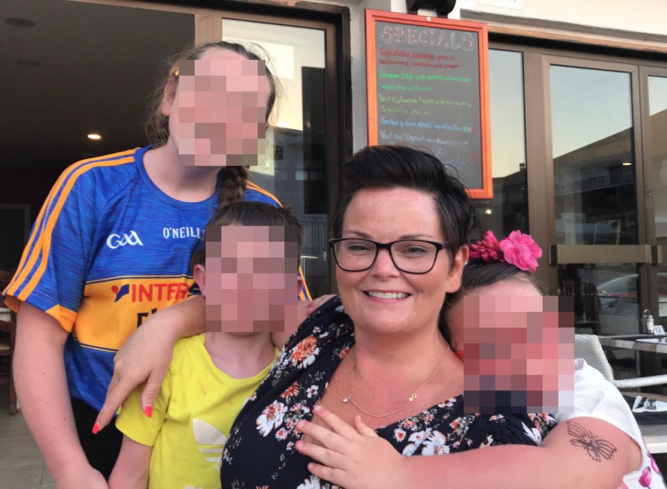 a woman stands with three children in front of a sign that says specials