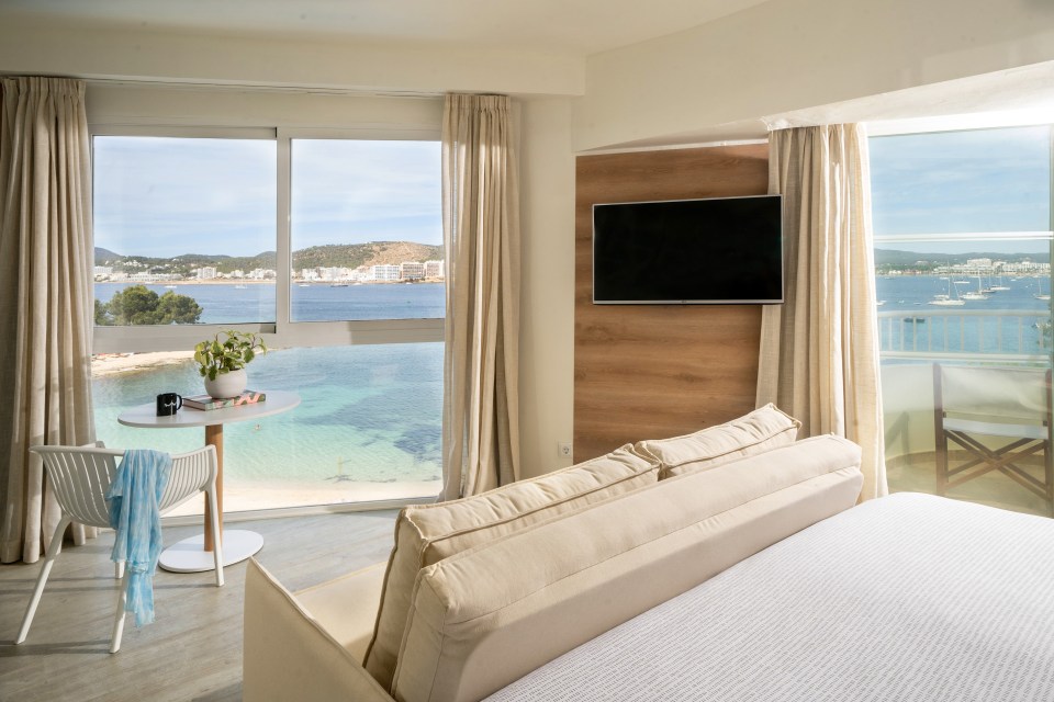 a hotel room with a view of the ocean