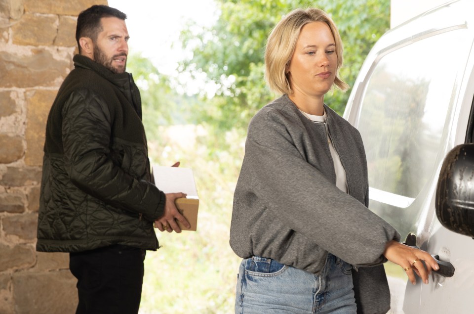 a man and a woman are standing next to a white van