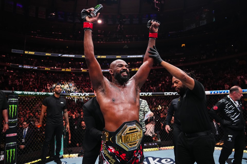 a man in a boxing ring with a monster energy drink in his hand