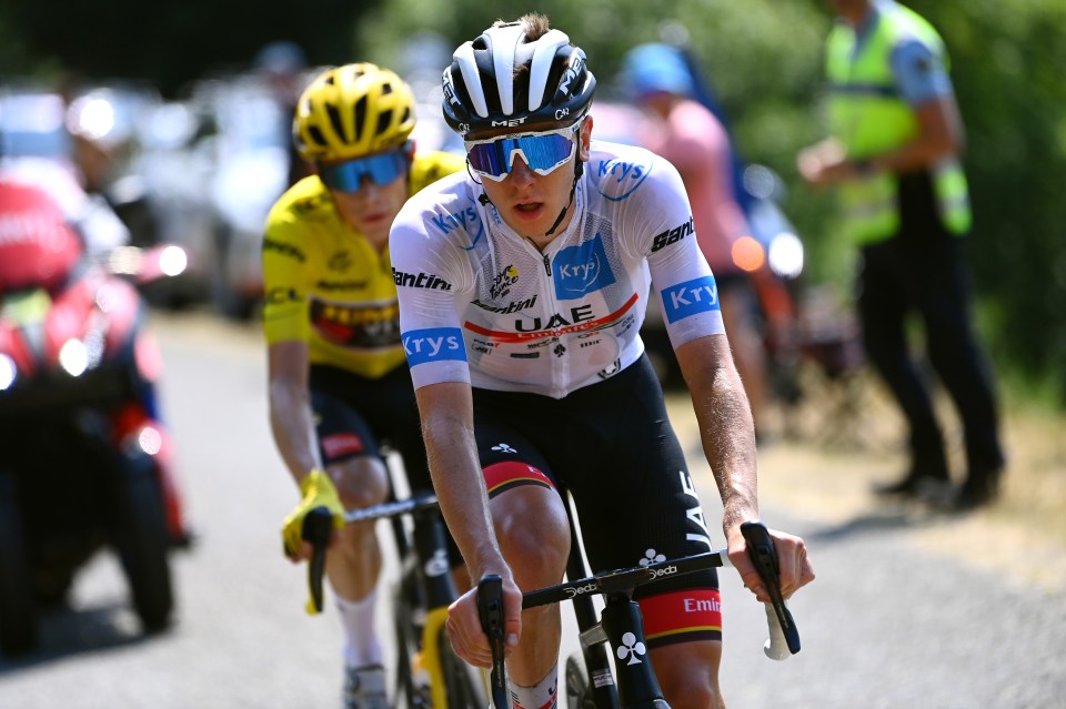 a man riding a bike with the word uae on his jersey