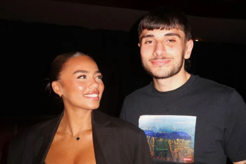 a man and a woman are standing next to each other and smiling .