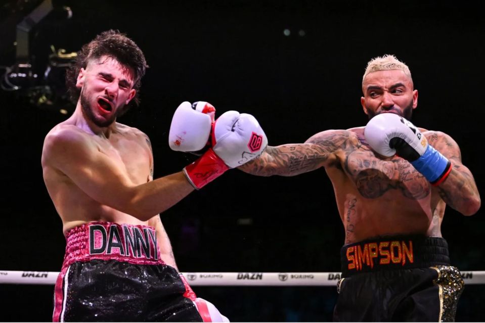 two boxers in a ring one of whom has the word simpson on his shorts
