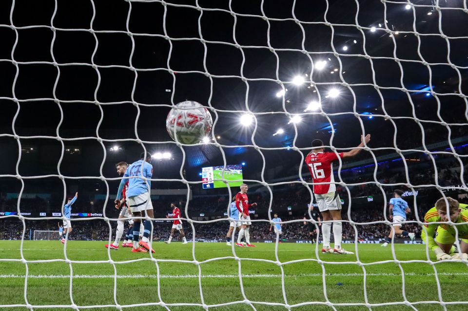 Manchester City player scoring a goal.
