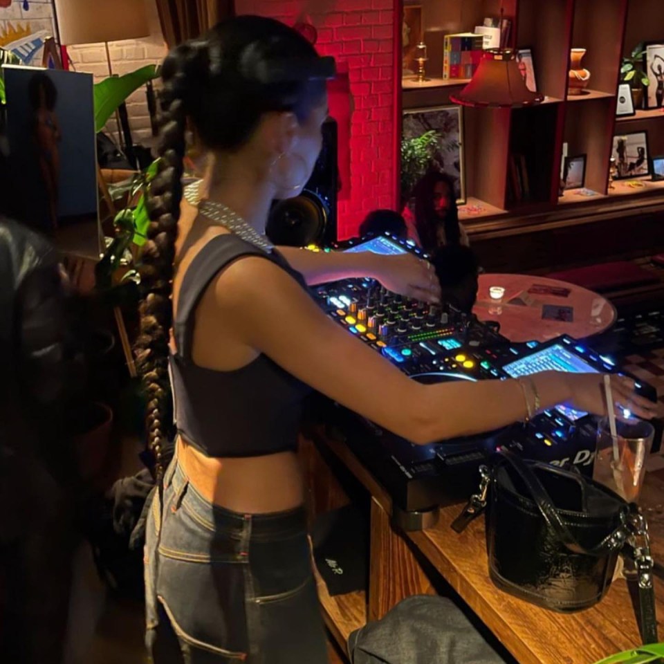 a woman is playing music on a dj mixer