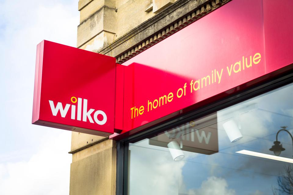a red sign for wilko the home of family value