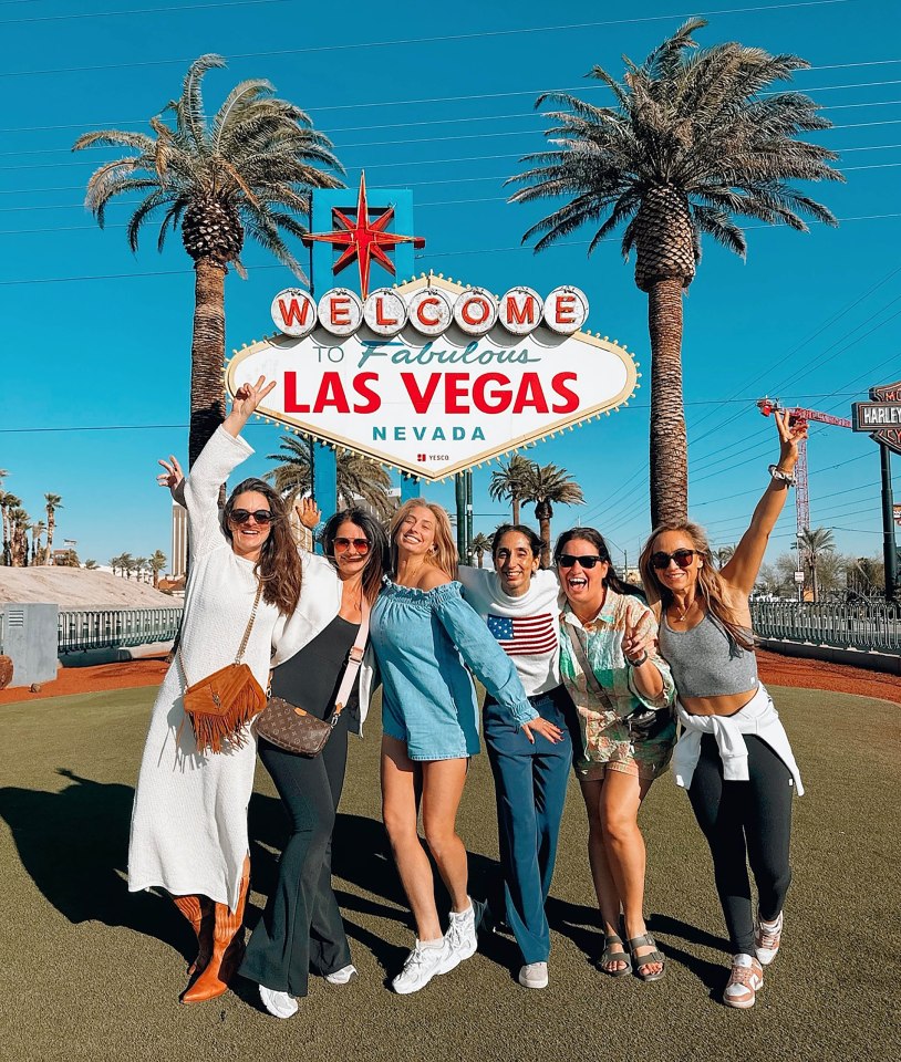 a group of women pose in front of a welcome to fabulous las vegas sign