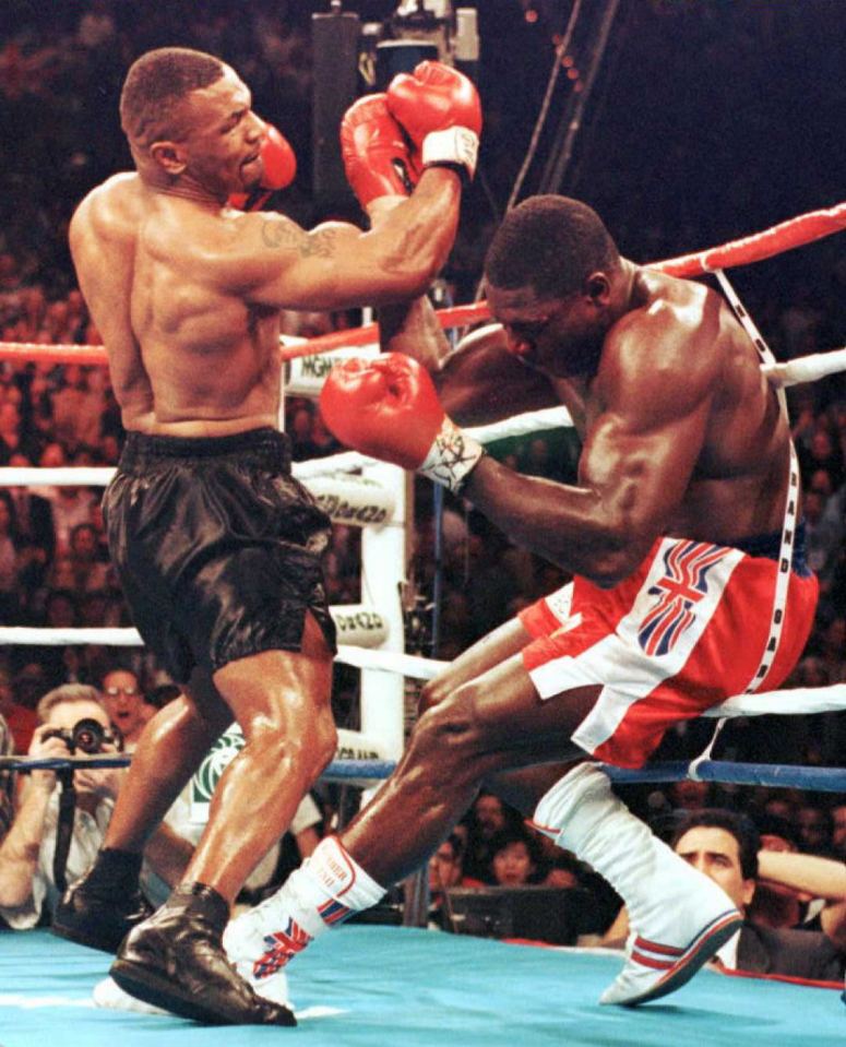 two boxers are fighting in a ring and one has a british flag on his shorts