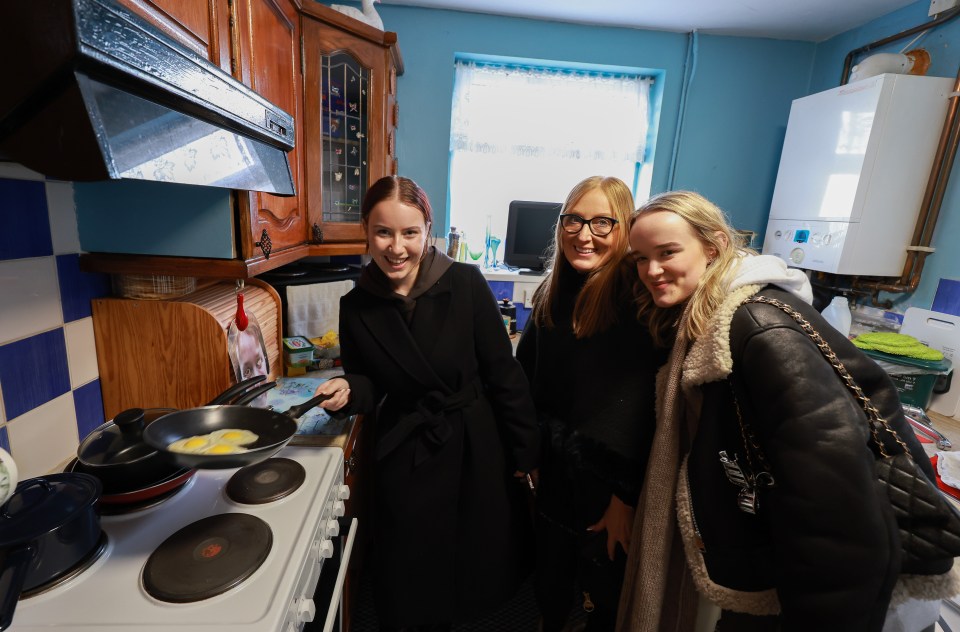 Three women in a kitchen cooking eggs.