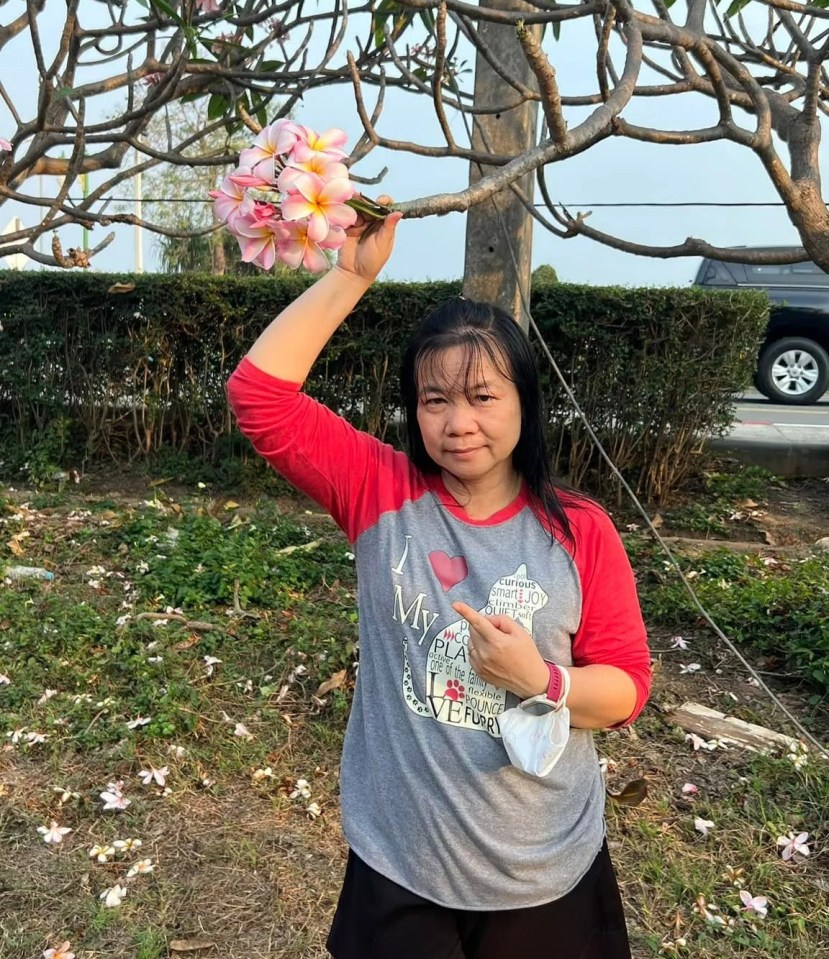 Woman holding pink flowers.