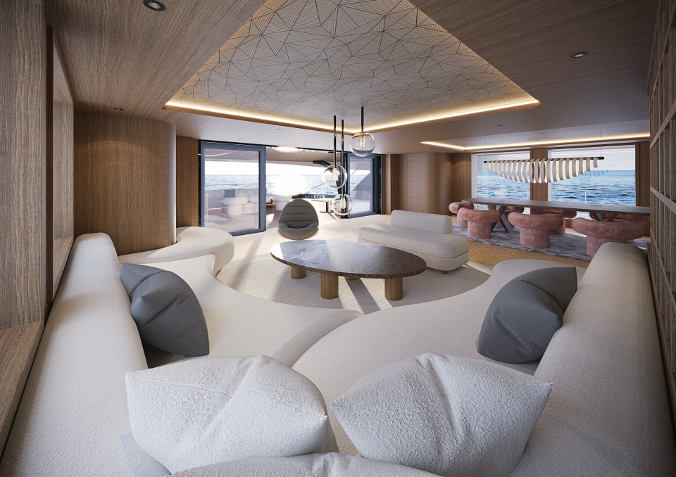 Interior view of the Solsea superyacht's main salon, showcasing an ocean view through large windows.