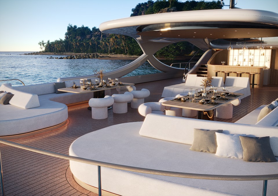 The Solsea superyacht's exterior deck features seating areas, dining tables, and a bar, with 180-degree ocean views.