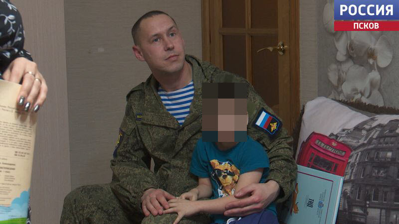 A Russian soldier and his adopted child.