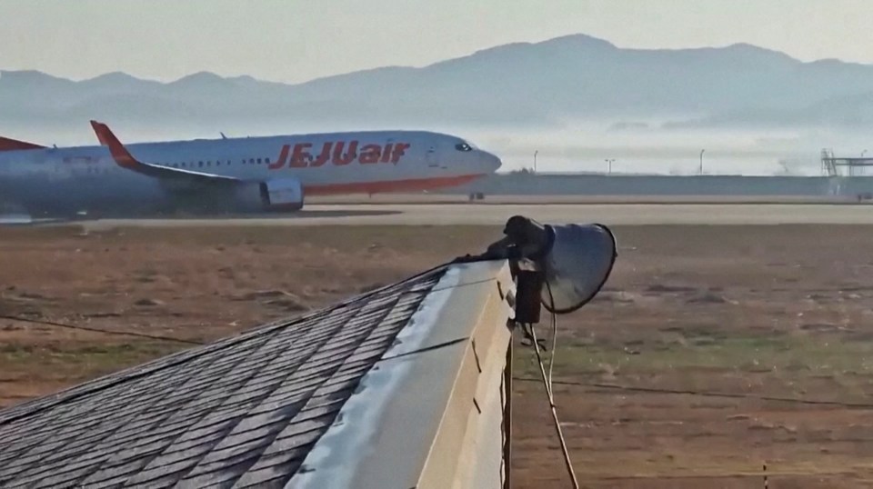 Jeju Air flight 7C2216 on the runway at Muan International Airport after a crash landing.
