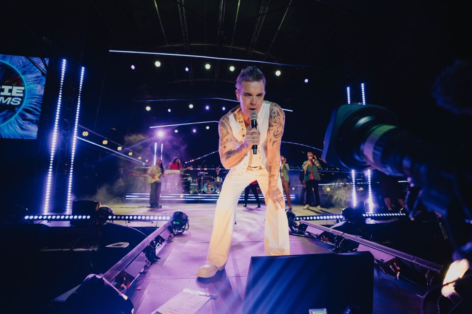 Robbie Williams performing on stage at a New Year's Eve concert in Sydney.