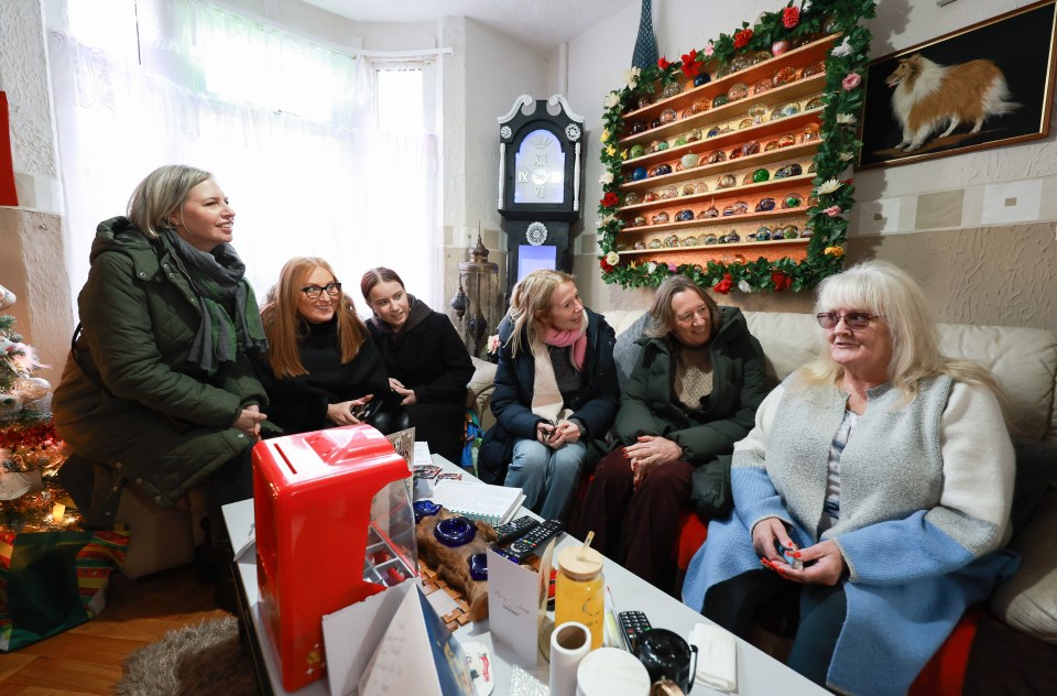 Glenda Kenyon, owner of the house used in Gavin & Stacey, sits on a sofa with visitors in her living room.
