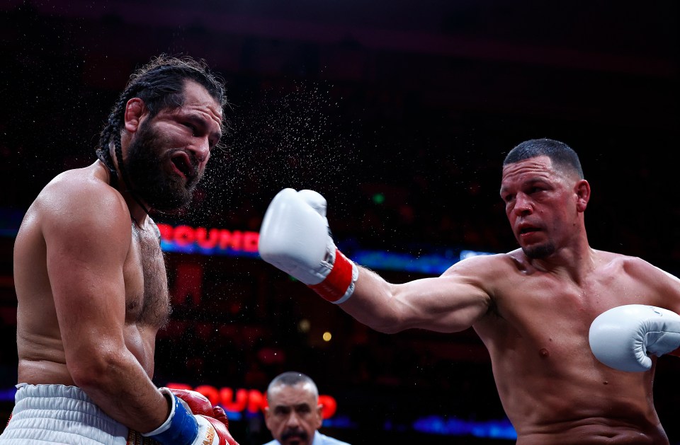 Nate Diaz landing a punch on Jorge Masvidal during a boxing match.