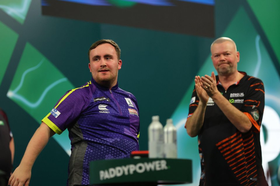 Luke Littler applauded by Raymond van Barneveld after defeating Raymond van Barneveld to reach the Quarter-Finals at Alexandra Palace in London, UK, on December 30, 2023.<br />
Image by Action Plus Sports/Alamy Live News.