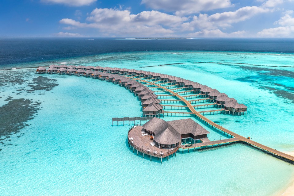 Aerial view of overwater bungalows in the Maldives.