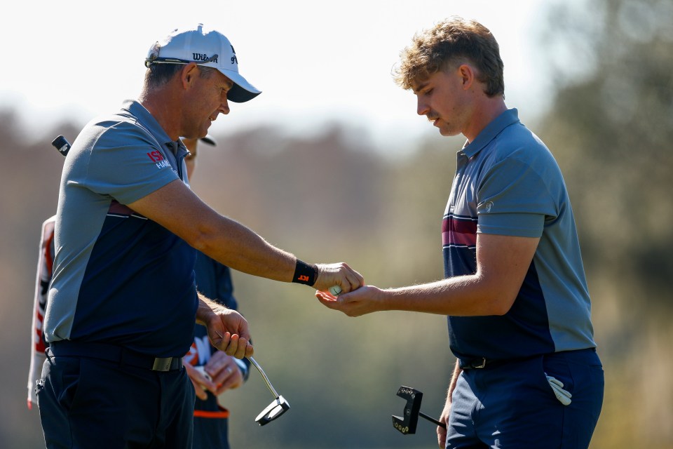 Padraig Harrington handing a golf ball to his son.