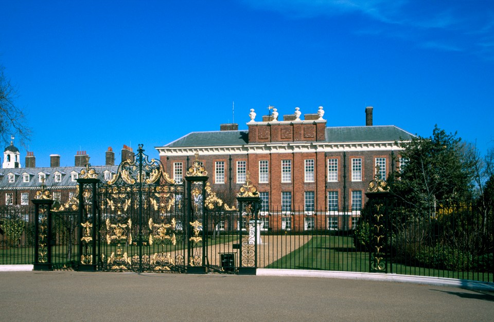 Kensington Palace in London, seen through ornate gates.