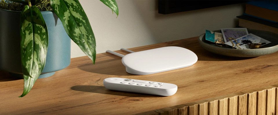 Streaming device and remote on wooden surface.