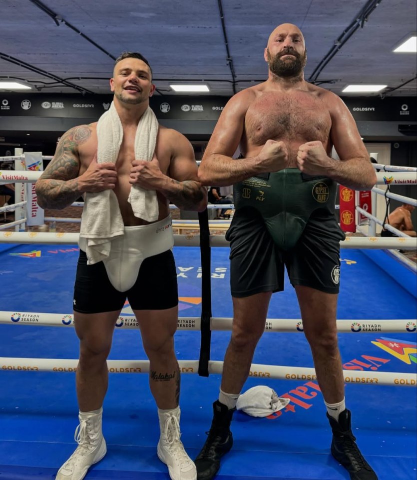 Tyson Fury and another boxer in a boxing ring.