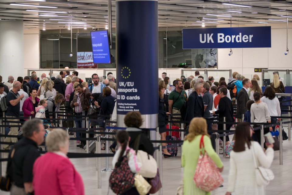 Passengers waiting in line at UK Border Control.