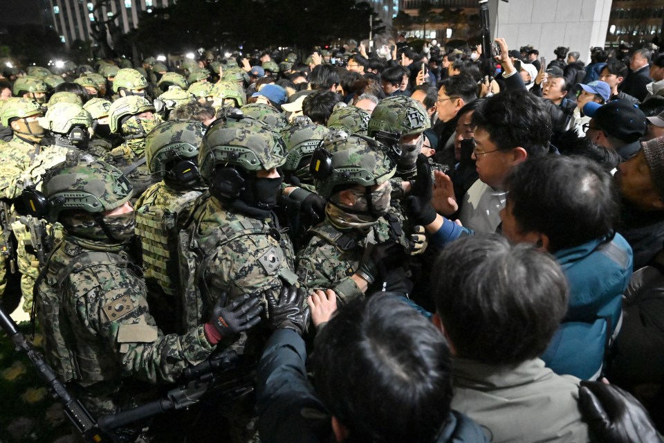 South Korean soldiers clash with civilians outside the National Assembly building.
