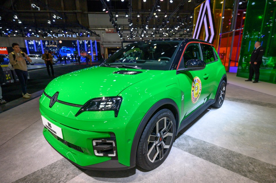 Green Renault 5 E-Tech electric car at a car show.