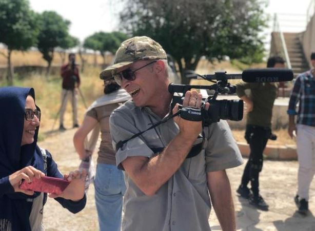 Man filming with a camcorder.