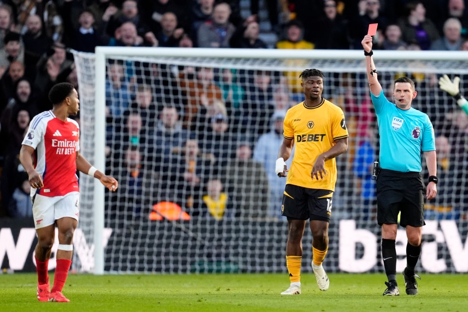 Soccer referee showing a red card to a player.