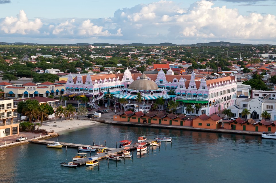 Aerial view of Oranjestad, Aruba, showing the waterfront and colorful buildings.